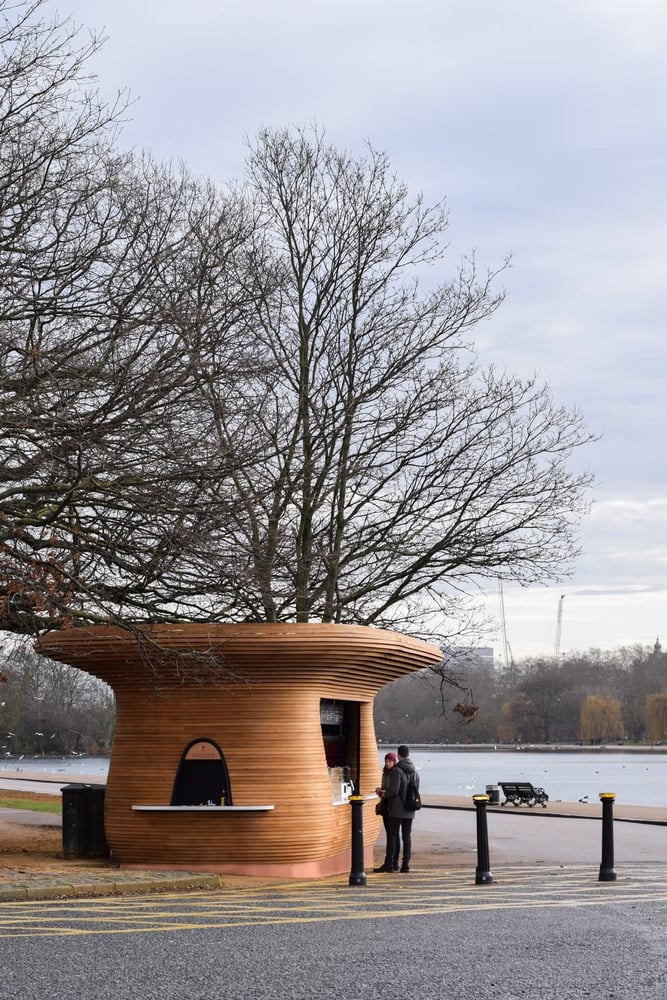 Mizzi Studio refreshment kiosk near a body of water in London's Royal Parks.