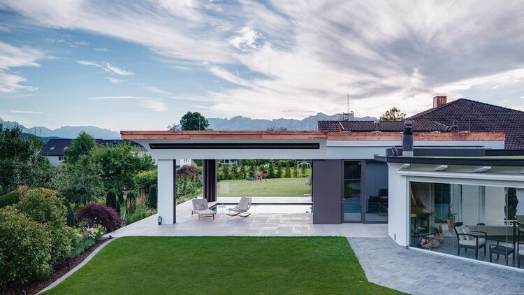 Air-Lux descending windows installed around a large patio space.