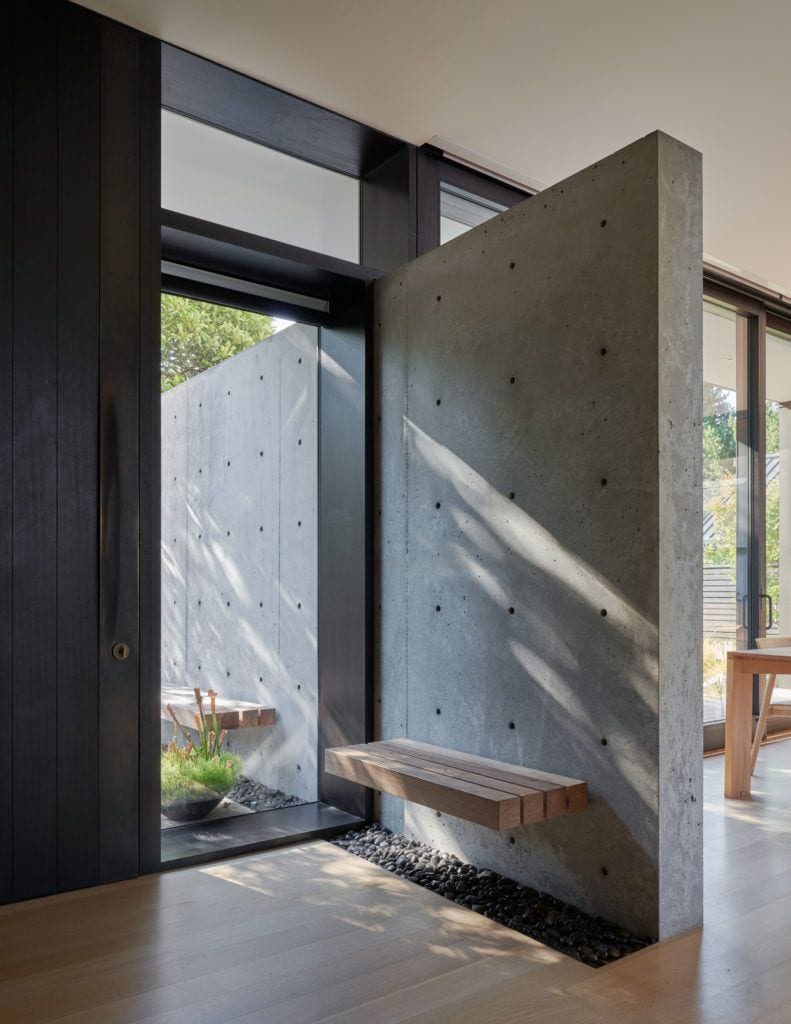 Hard concrete partitions juxtapose warm wooden features inside the Fauntleroy Residence