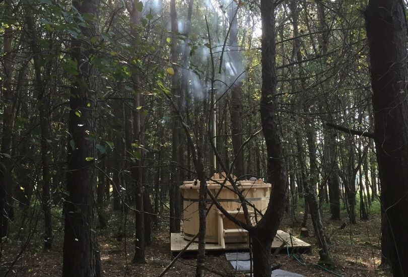 Cozy forest hot tub located right outside Adam Collier-Woods' renovated 