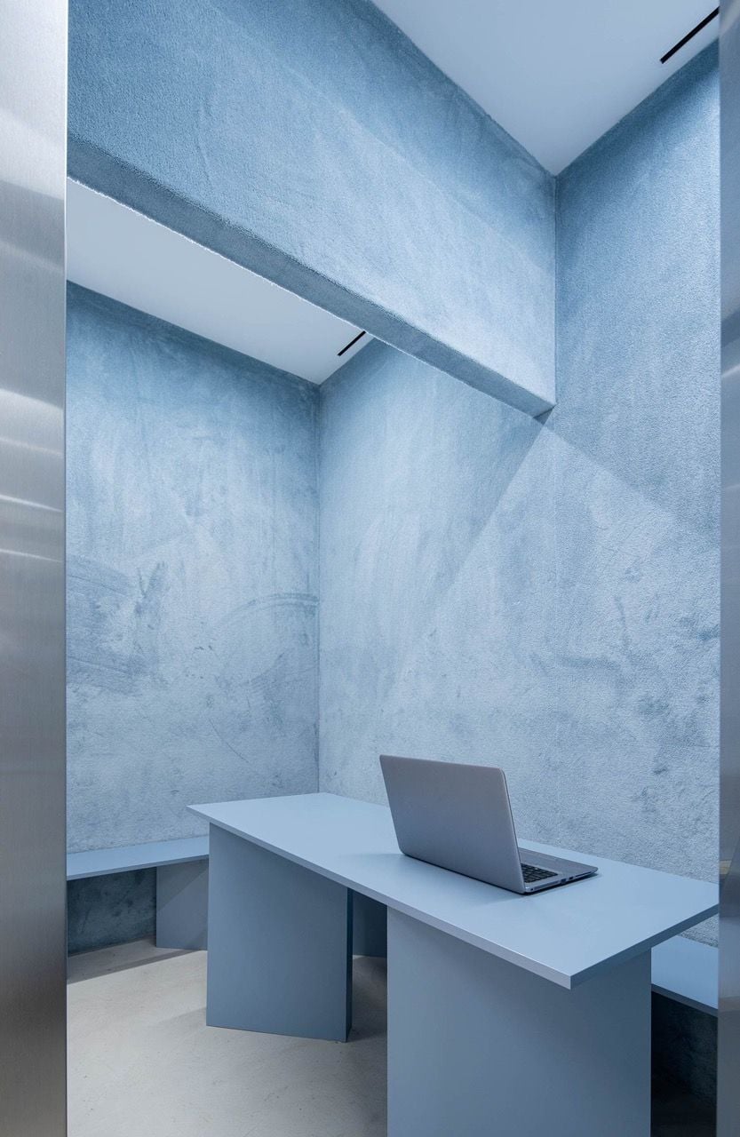 Pale blue office spaces like this one offer a calming contrast to the Impress dental clinic's menacing 