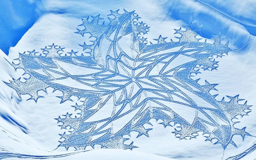 Star-shaped geometric snow art by Simon Beck.