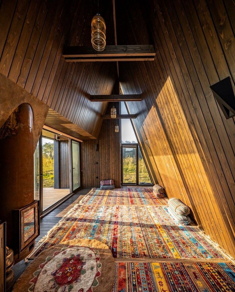 Cozy carpeted interiors of the Shaygan Gostar-designed Wicker House A-frame cabin.