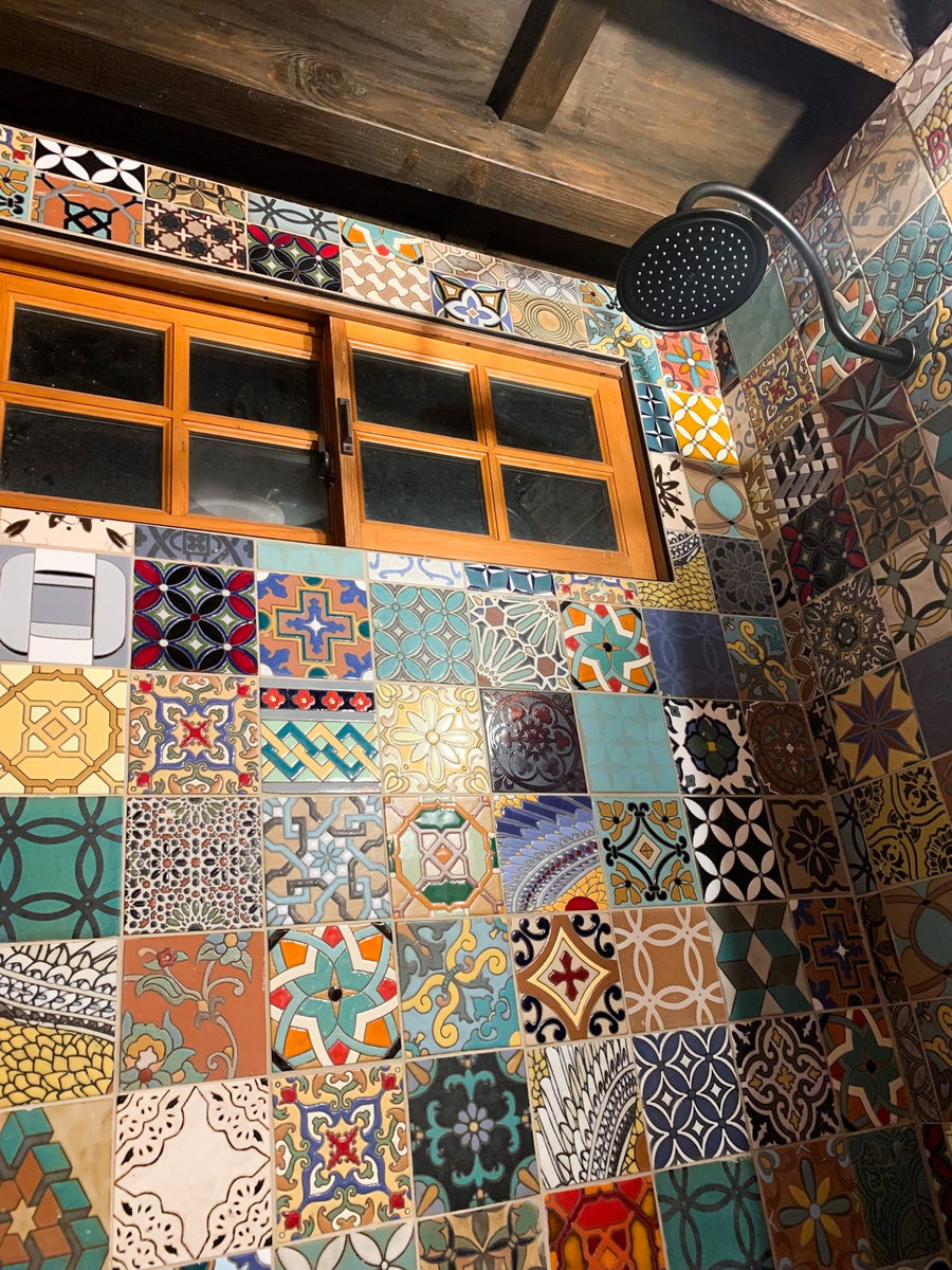 Colorful wall of tiles inside the restored Vardolandia tiny home wagon.