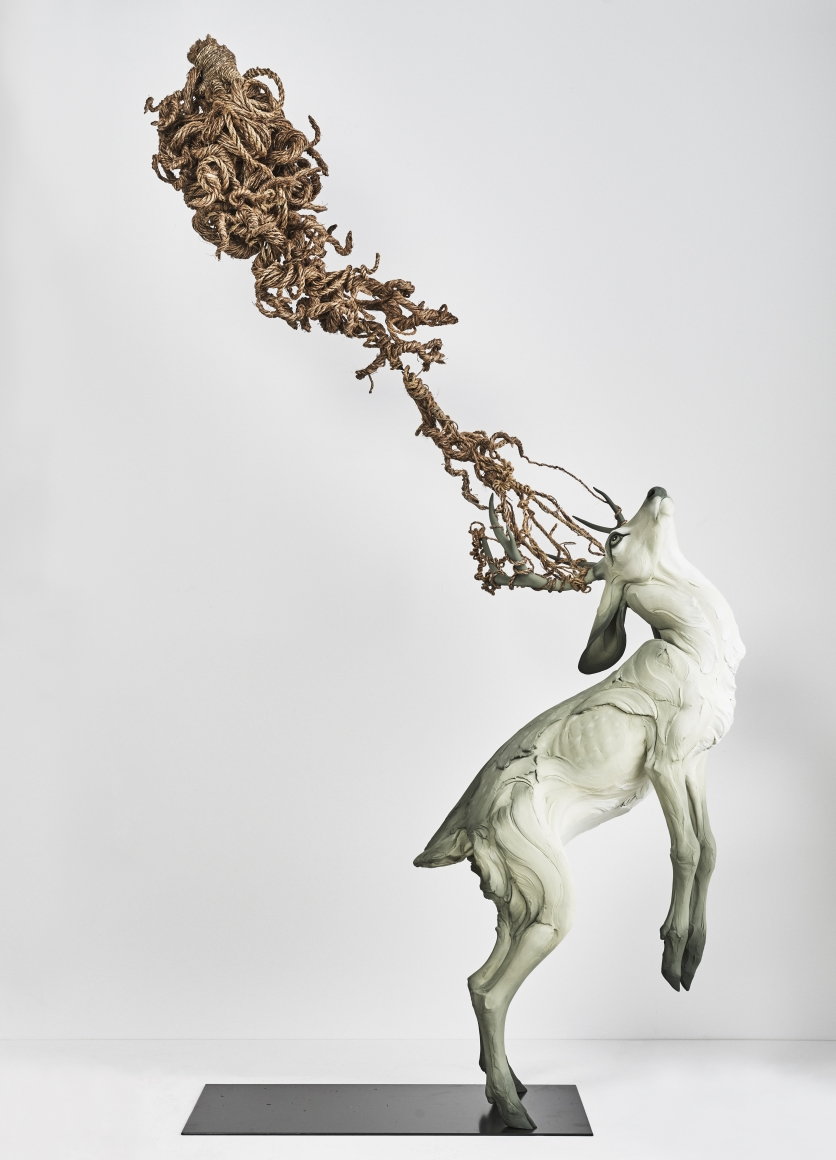 Proud sculpture of a buck standing on his hind legs, by artist Beth Cavener. 