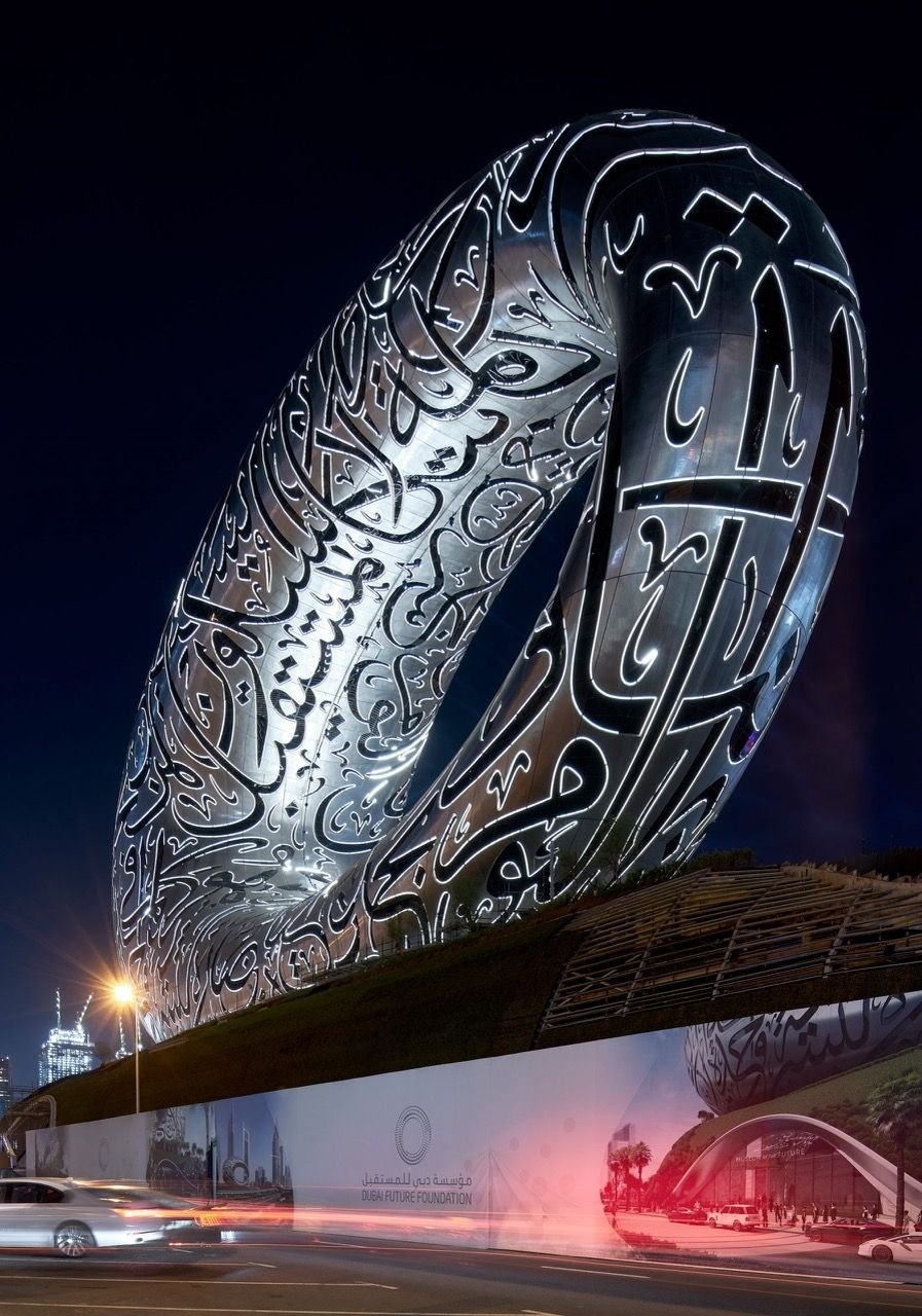 Nighttime upward view at Dubai's shiny Museum of the Future.