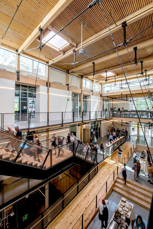 Students and faculty members move throughout the simple, sustainable interiors of the Kendeda Building.
