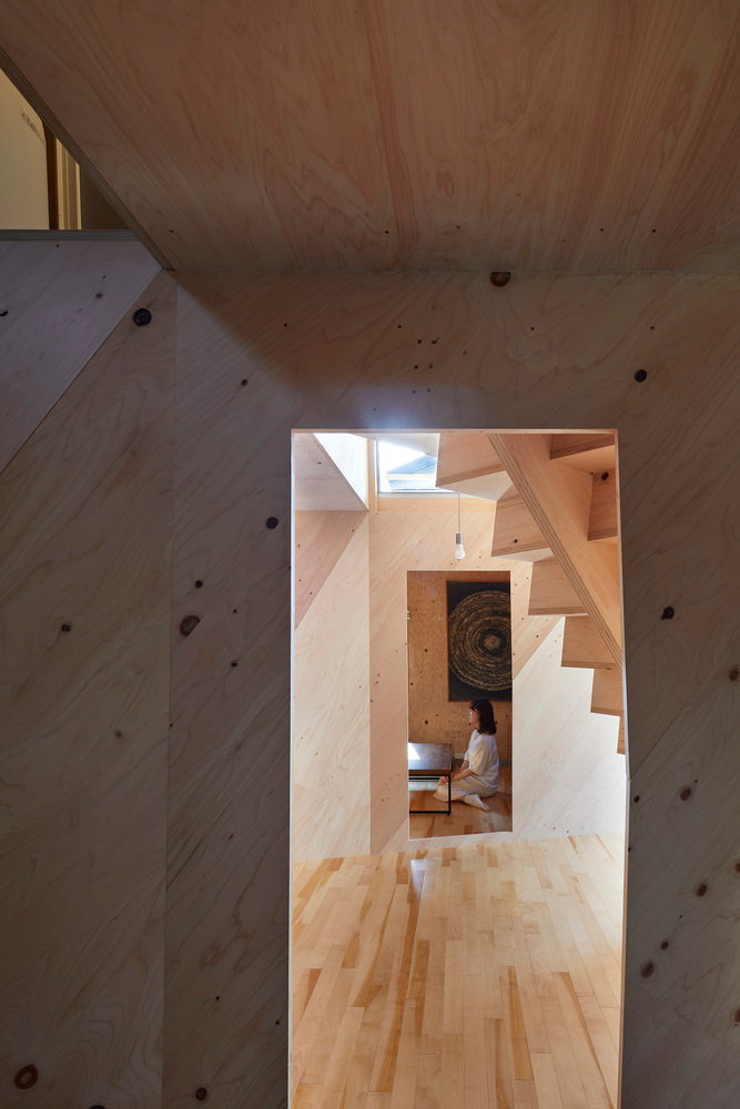The angular, staircase heavy interiors of Alphaville Architects 24-mm plywood tiny home in Kyoto.  