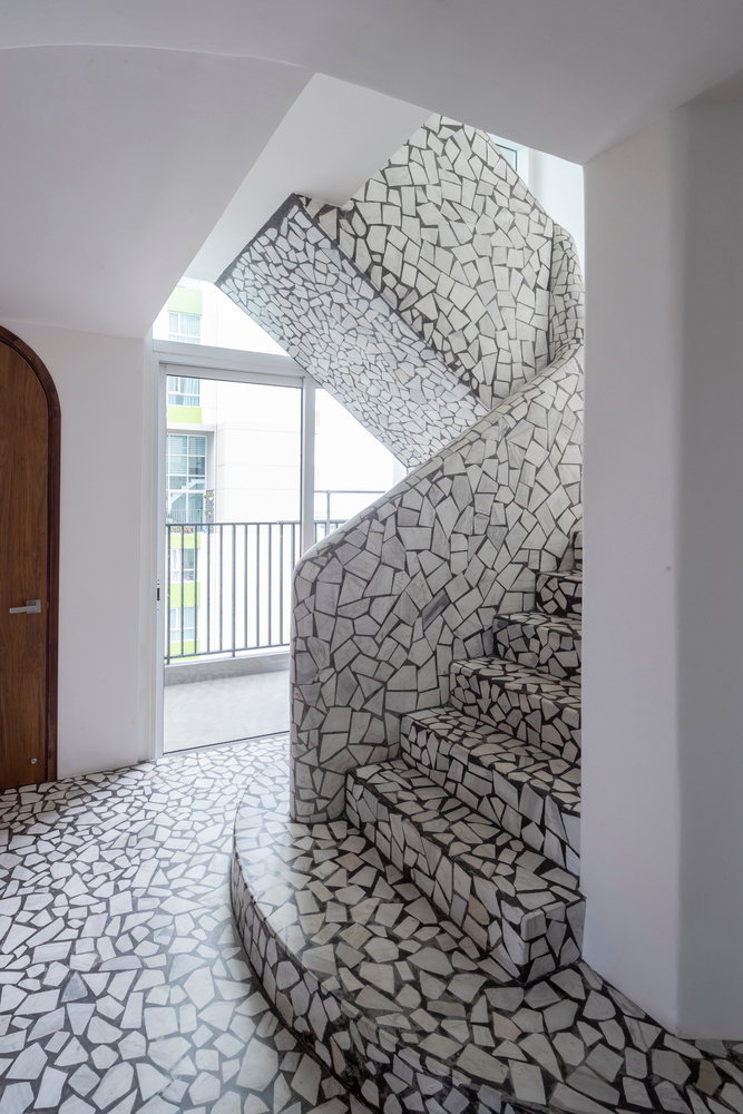 A bold terrazzo staircase inside the ultramodern Mai Apartment.