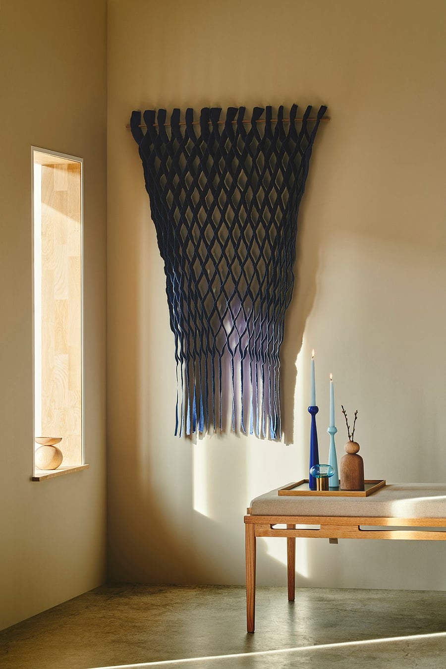 Honeycomb-like hanging textiles from the FLOW collection bring splashes of color and elegance to a modern living space.