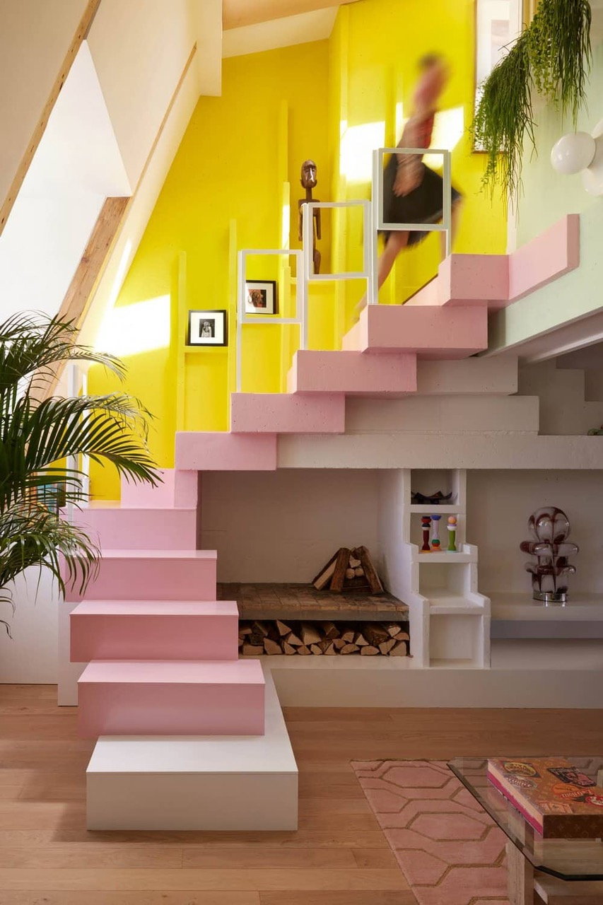 Soft pink staircase at the center of the Manuelle Gautrand-renovated 17th-century Paris apartment. 