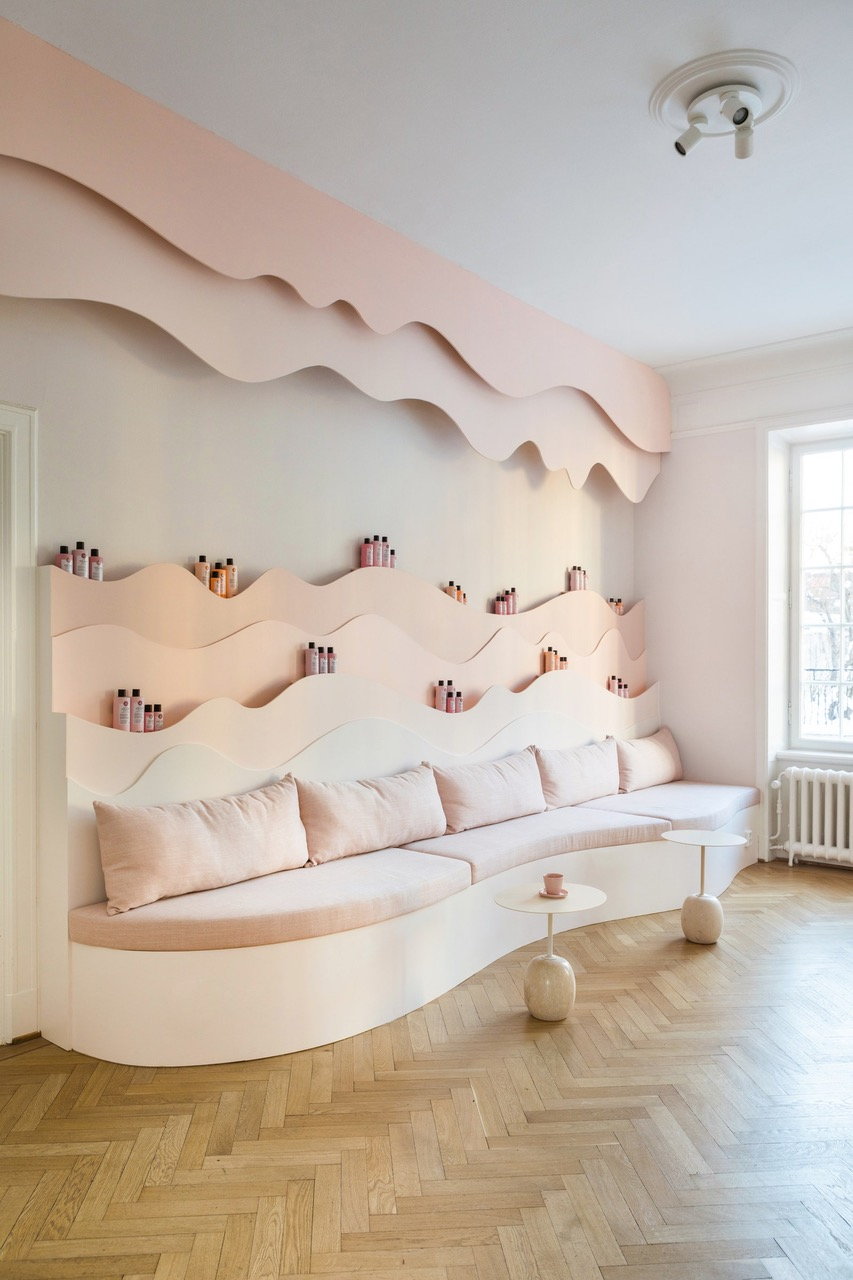 Undulating product shelves in the Maria Nila Salon draw inspiration from natural elements like waves and trees.