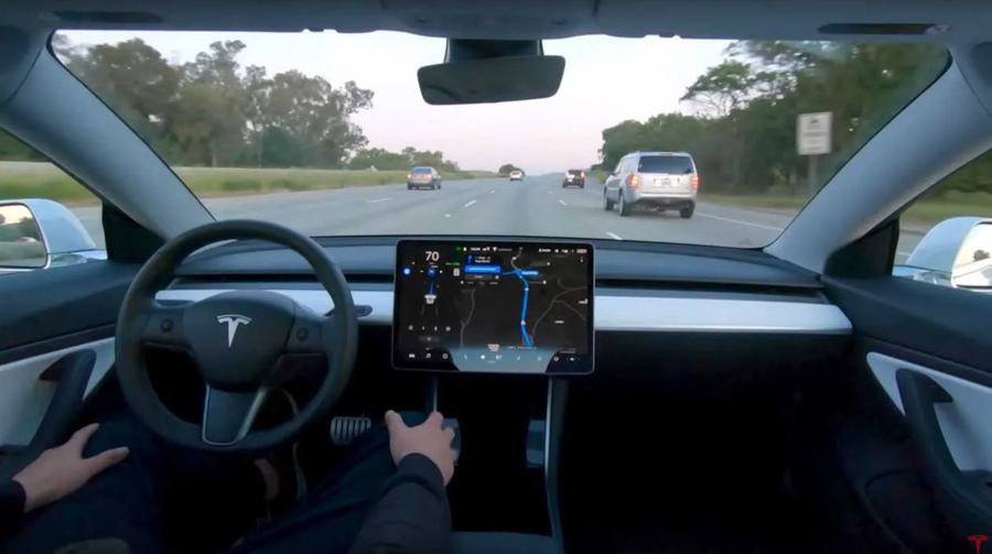 Driver relaxes with their hands on their knees while Tesla's (not quite) Beta v9 full self-driving system does the work. 