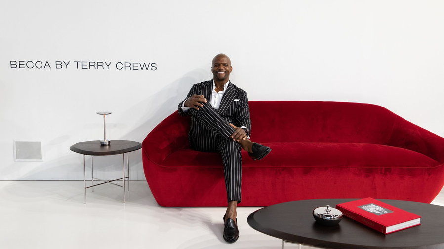 Actor Terry Crews sits in one of the couches from his new Becca furniture collection