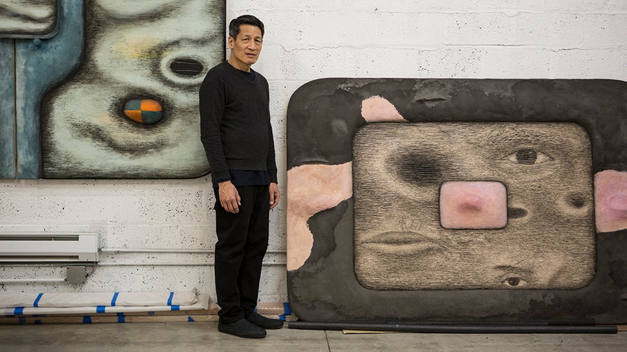 Artist Tishan Hsu stands in front of his technology-infused artworks.