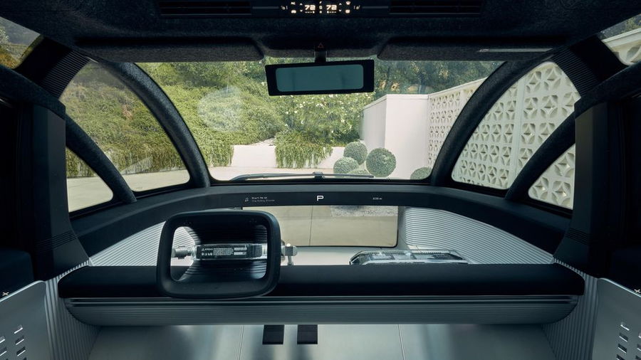 A sleek, futuristic dashboard adorns the front of the Canoo. 