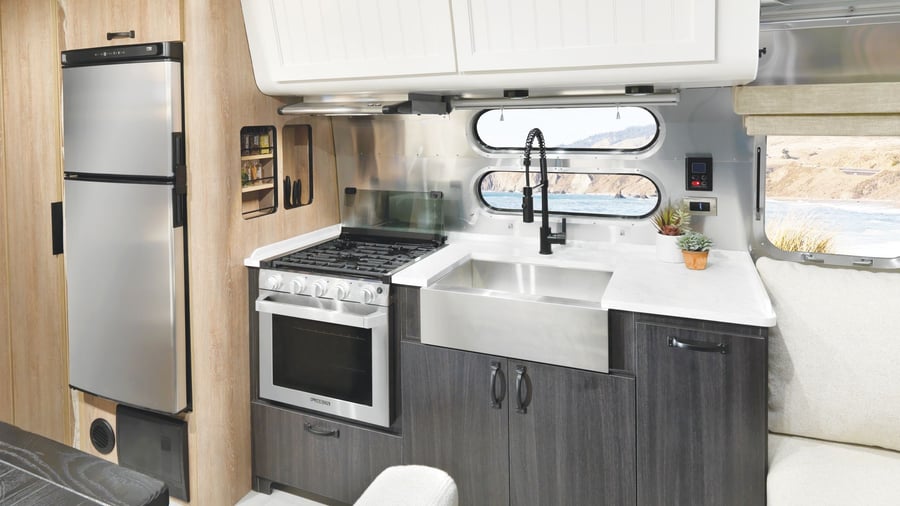 Sleek, modern kitchen area inside the new Airstream X Pottery Barn Travel Trailer. 