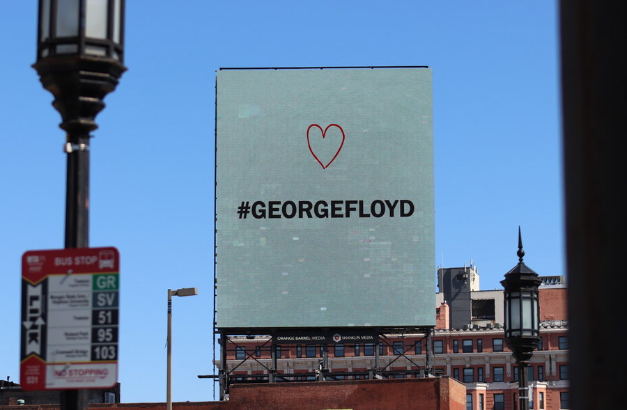 The social media hashtag #georgefloyd is displayed in a simple black and white graphic, with a heart placed just above the text.