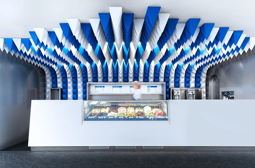 The Tobia Zambotti-designed interiors of this Icelandic ice cream store are defined by fun blue and white foam 