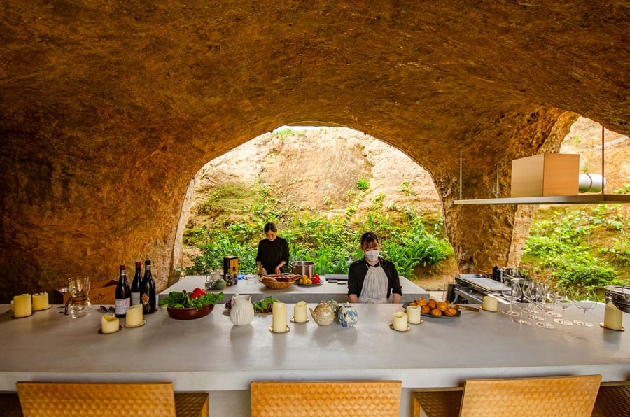 Chefs prepare a delicious meal in the House and Restaurant Cave's expansive kitchen area.