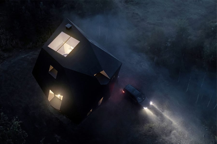 Overhead view of the Ateljé Sotamaa-designed Meteorite cabin gives off an otherworldly glow in the Finnish forest at dusk. 