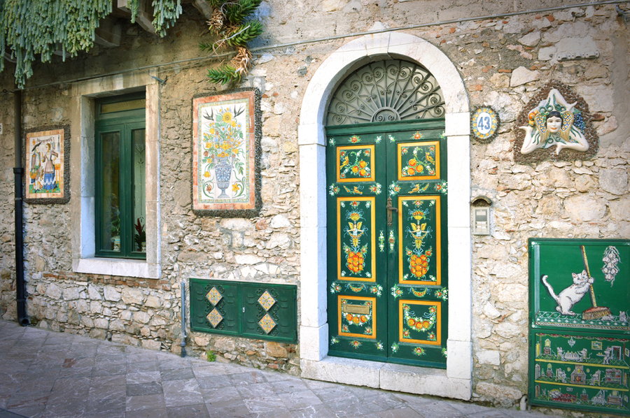 The front door of the Giammona House in Taormina is adorned in all sorts of traditional Sicilian colors and patterns.