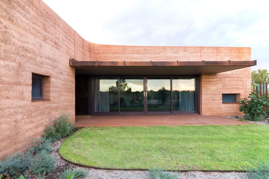 One of many rammed earth guest houses that make up the large zig-zagging 