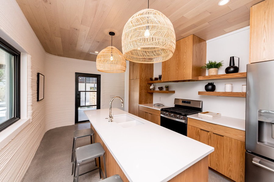 Modern kitchen area inside Logan Architecture and ICON's 3D printed homes in Austin.