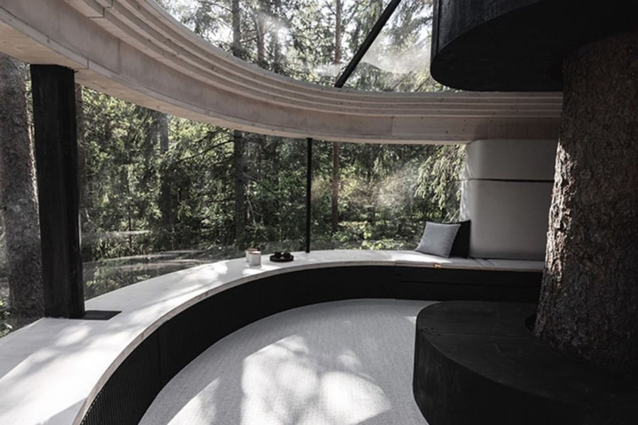 Viewing bench wraps around the KOJA treehouse's glass window for more cozier sightseeing.