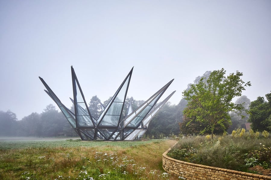 Thomas Heatherwick's sculptural Glasshouse, fully unfurled on England's historic Woolbeding Gardens estate.