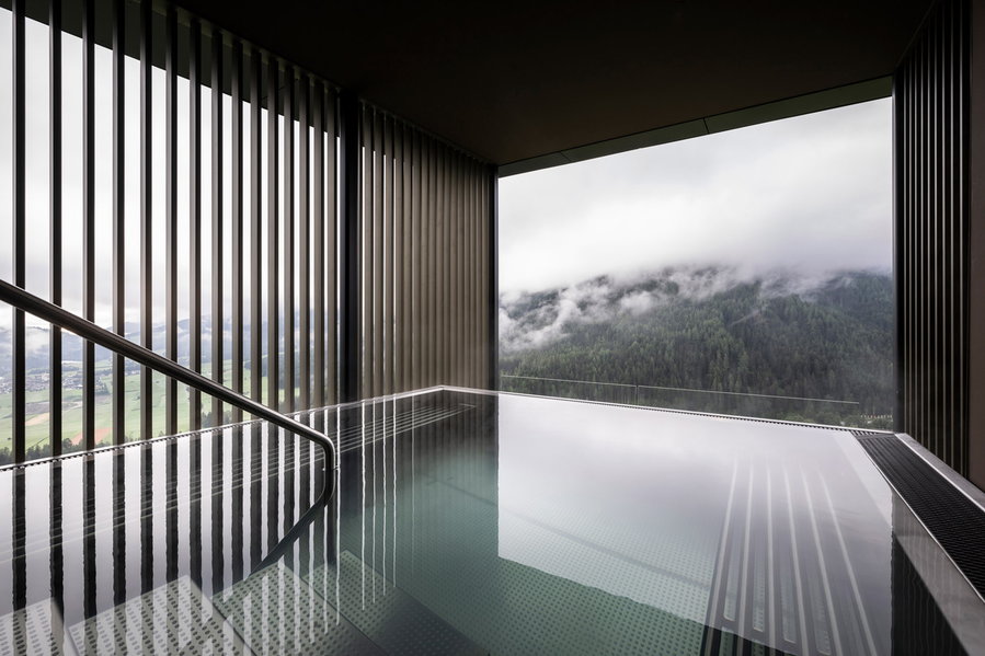 Sleek modern pool inside noa's cantilevered Hub of Huts hotel addition.