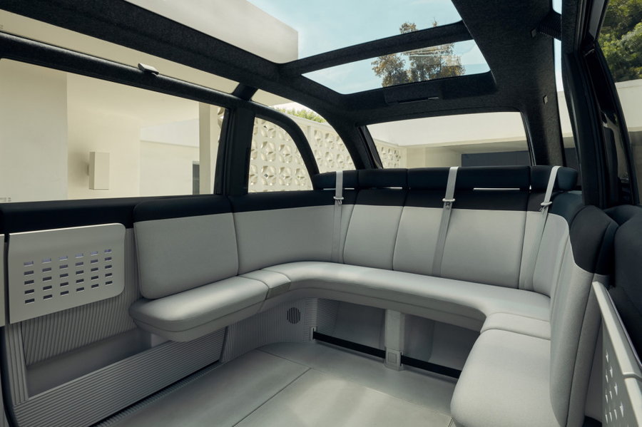 The spacious, bench-like back seat of the Canoo electric car.