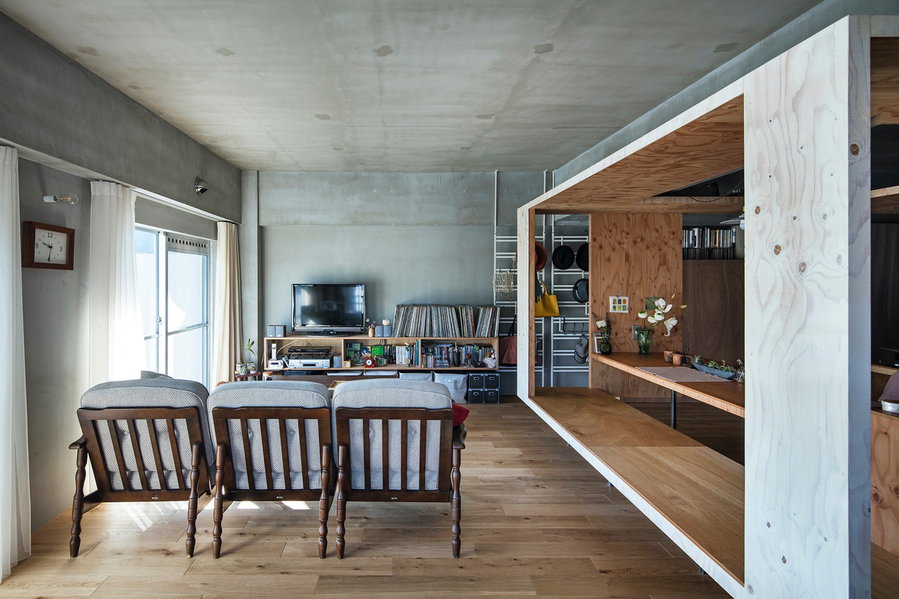 The living area inside the YAP-renovated Kyoto condo sits just next to the plywood box that contain's the unit's dining table.