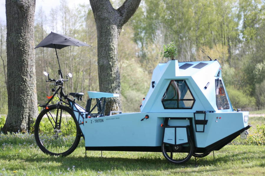 A protective umbrella pops up to protect whoever's pedaling the camper from the elements. 