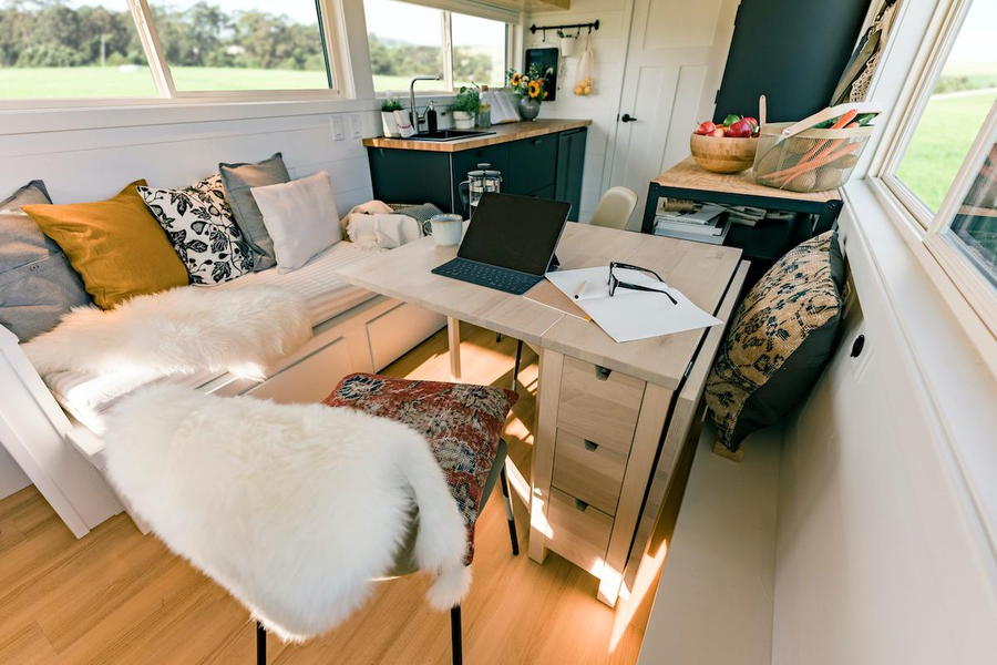 View inside IKEA's new tiny home offering, with a small workspace set up in the foreground.