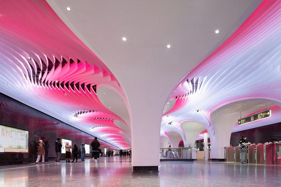 Renovated Yuyuan Station ceilings by XING Design glow a vibrant pink color.