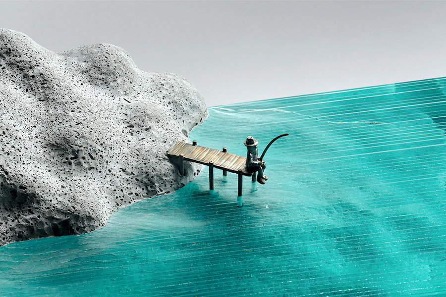 A breathtaking glass sculpture by Australian artist Ben Young, depicting a person fishing on the edge of a secluded boardwalk. 
