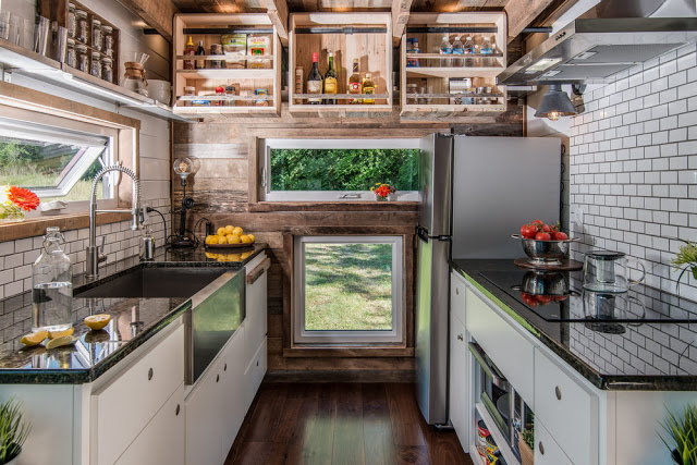 A beautifully furnished tiny home kitchen, complete with all the appliances an off-grid inhabitant could ever need. 
