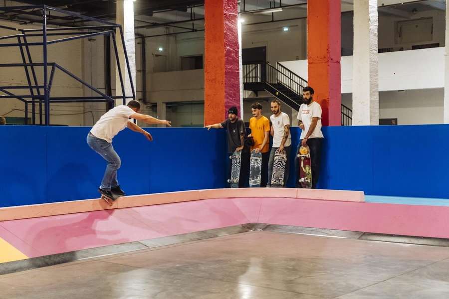 Skaters enjoy the brightly-colored ramps and half-pipes inside artist Yinka Ilori's Colorama Skatepark.