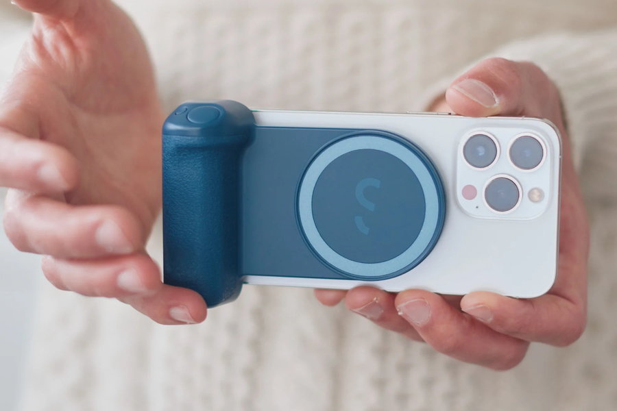 A closer look at a blue ShiftCam SnapGrip snapped onto a smartphone.