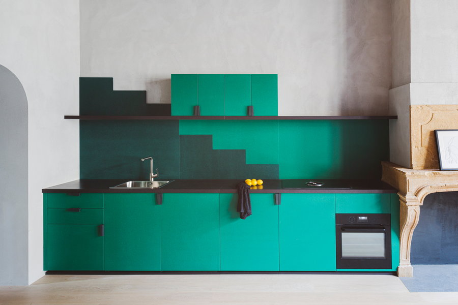Colorful, compact kitchen area in a Studio Razavi-renovated Renaissance-era apartment in Lyon, France.
