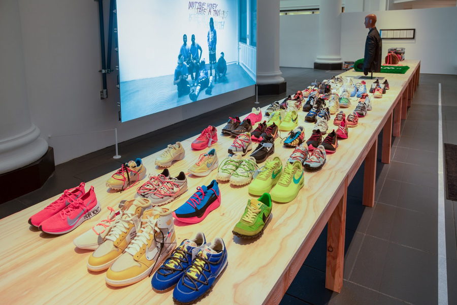 Colorful sneakers by Virgil Abloh fill a long table as part of the Brooklyn Museum's 