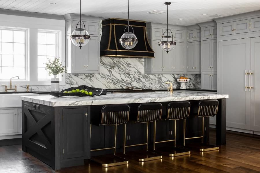 This contemporary kitchen space is packed with delightful details like a unique hood and lighting fixtures.