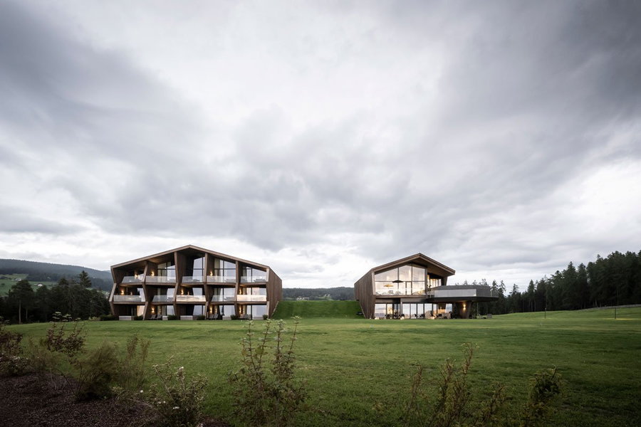 Exterior view of the two barn-like buildings that make up noa's new AEON Hotel in northern Italy.