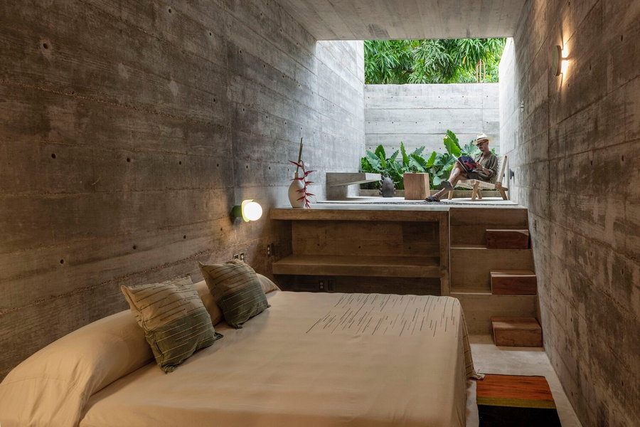 Cozy concrete guest room inside the Casa TO feels private without totally closing itself off to its natural surroundings.