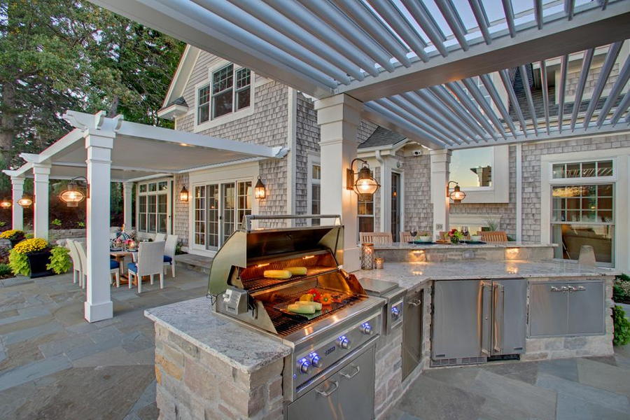 Stone countertops in this outdoor kitchen are sturdy and able to withstands the elements. 