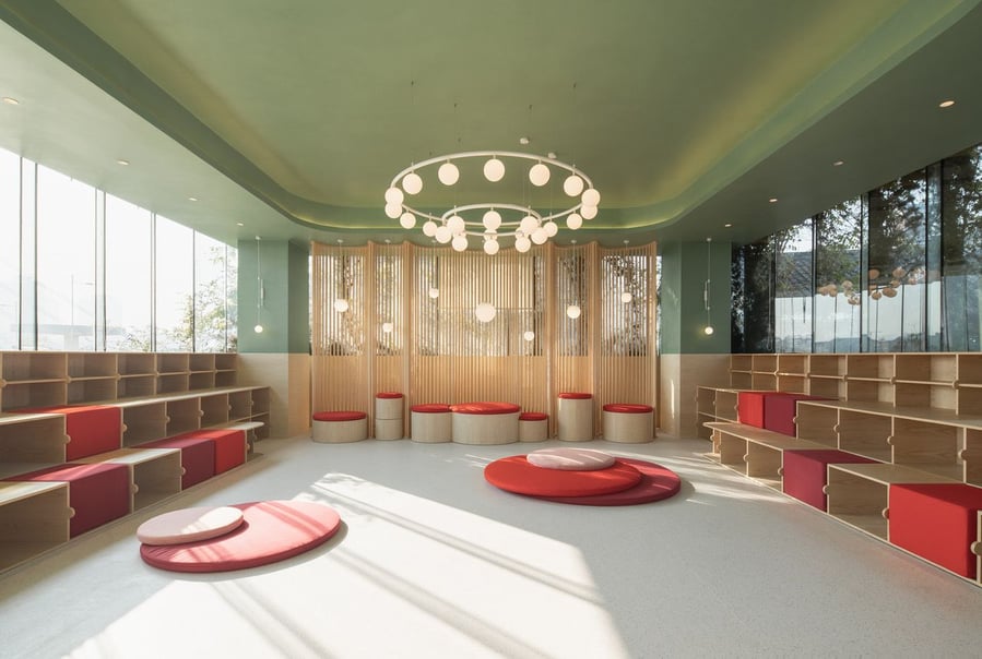 Spacious children's event/play space on the second floor of the bund Bund Office, adorned with soft pastel tones and soft carpeted surfaces.