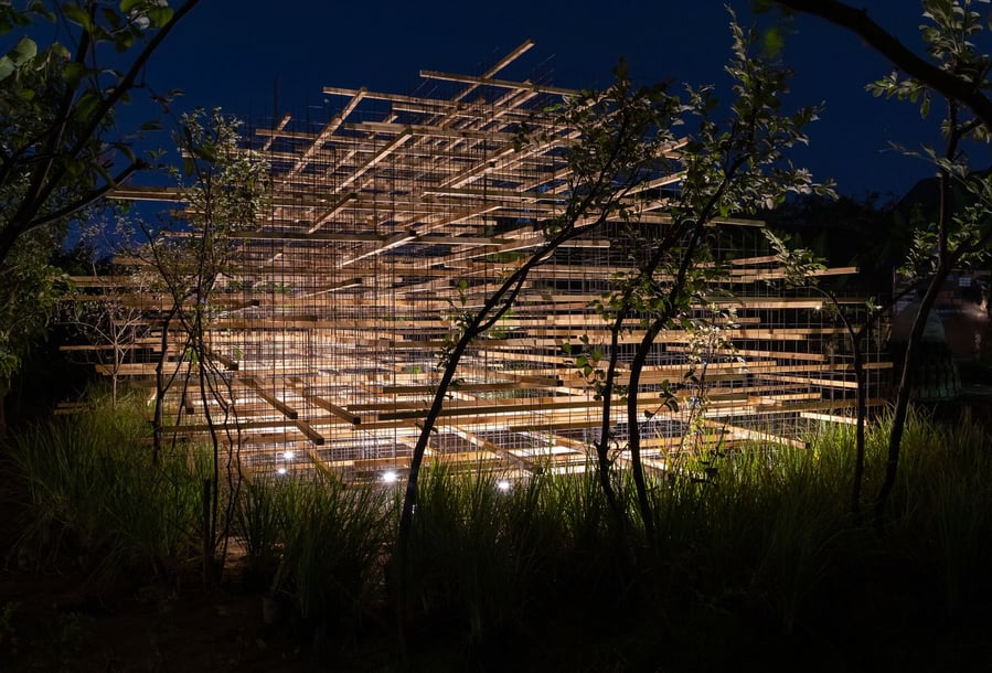 Close-up view of the wiry Straw Pavilion at night. 