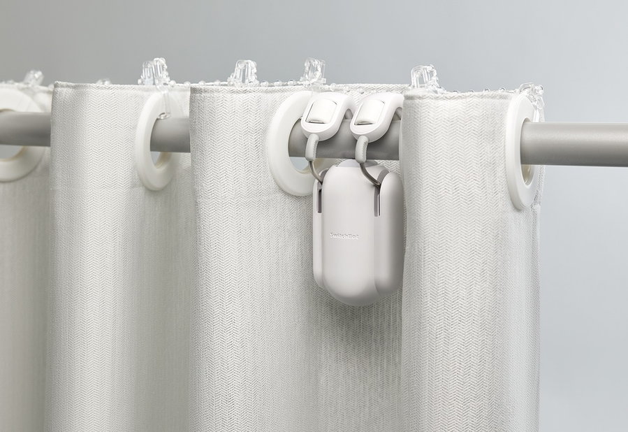 SwitchBot Smart Curtain Rod in use with grommet-style curtains.