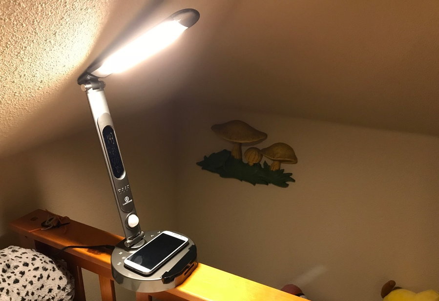A LumiCharge smart lamp lights up the room it's in while charging an iPhone.